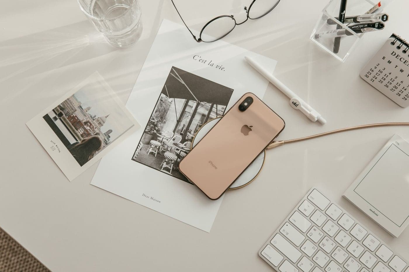 A desk with a phone, keyboard and printed campaign reference photographs